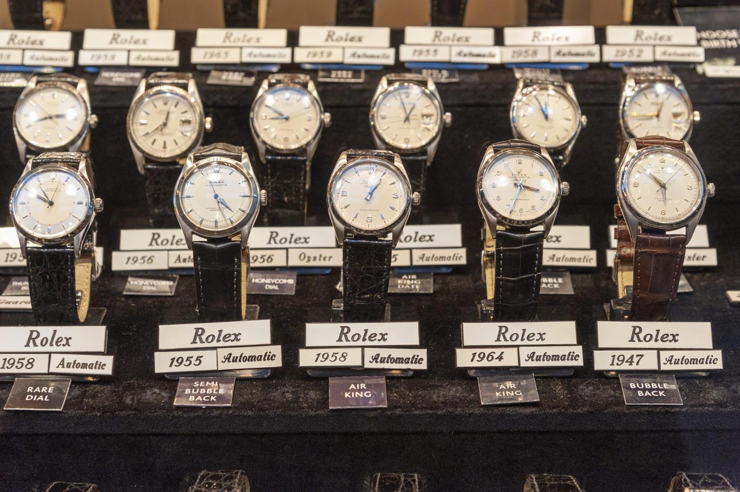 Vintage Rolex watches in shop display window, London, UK.