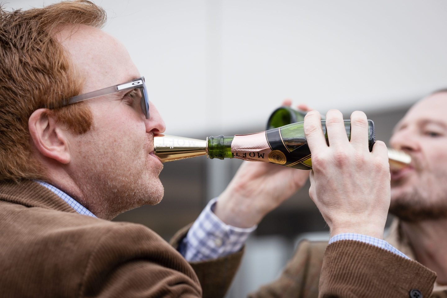 person drinking a bottle of moet & chandon champagne