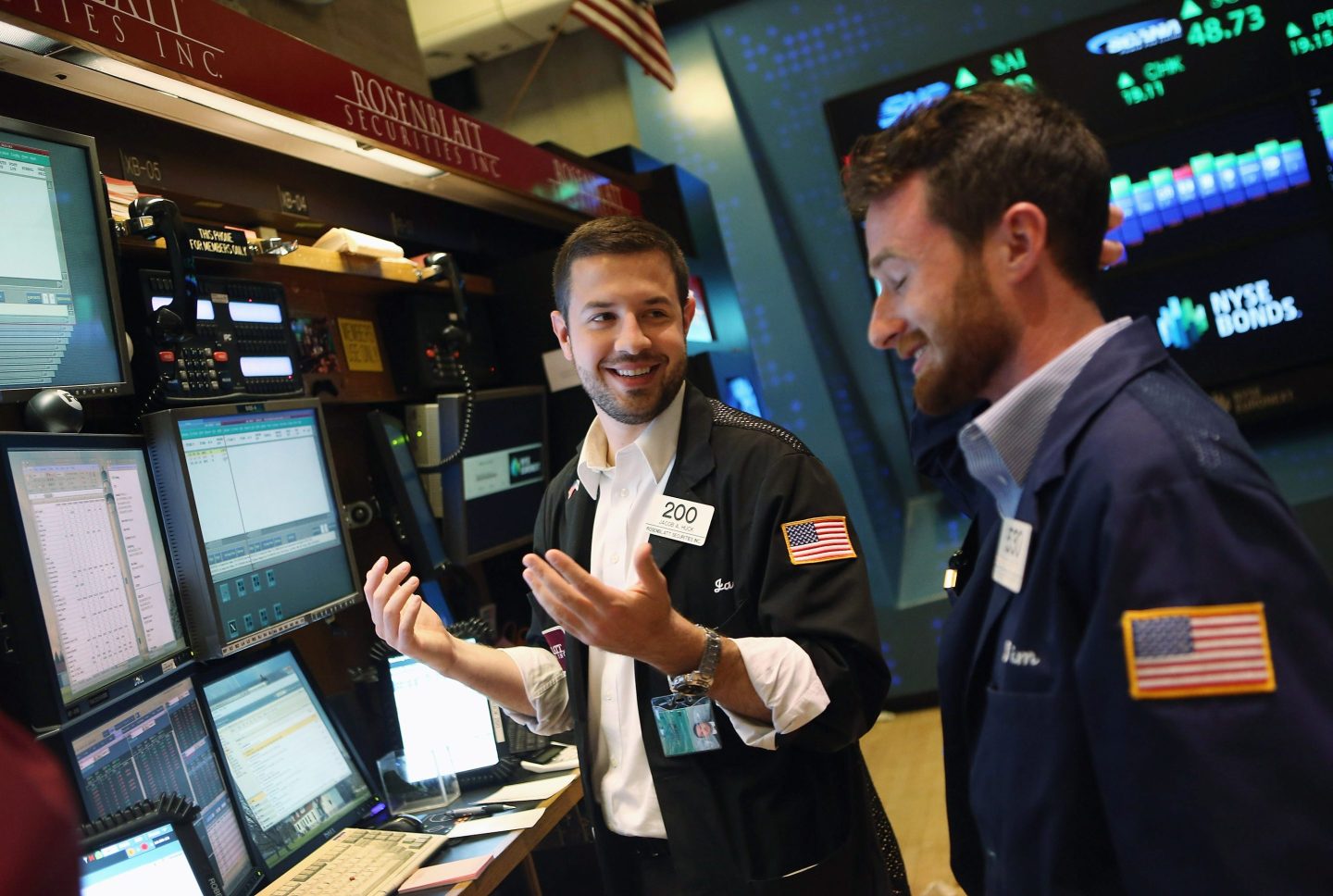 Traders smile at the New York Stock Exchange