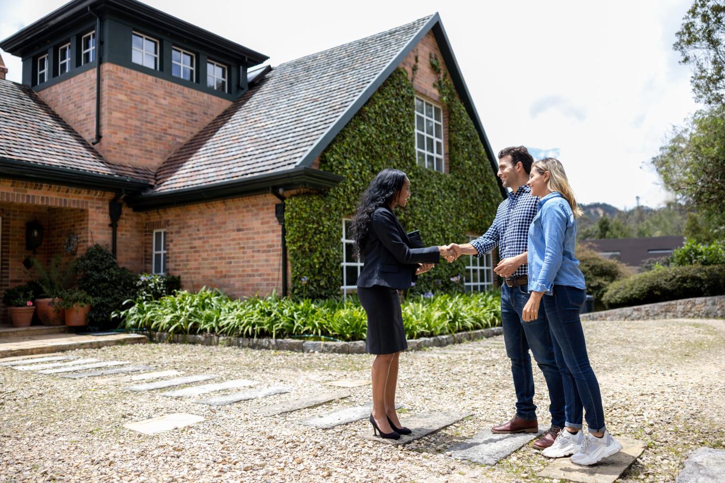 Home buyers shaking hands with realtor
