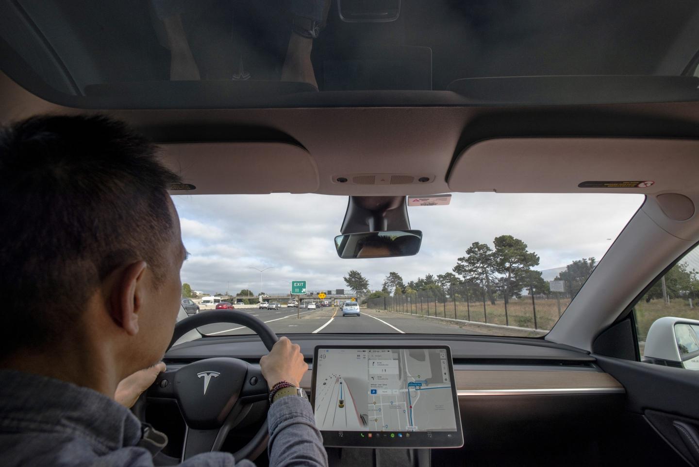 driver sits in Tesla Model Y