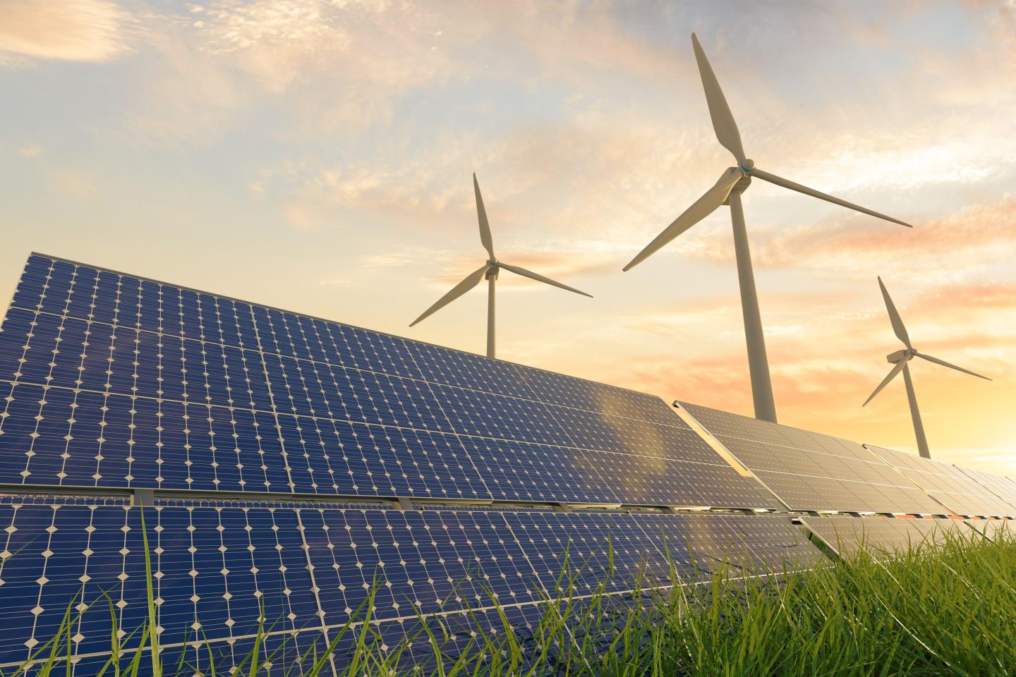wind turbines rise above solar panels