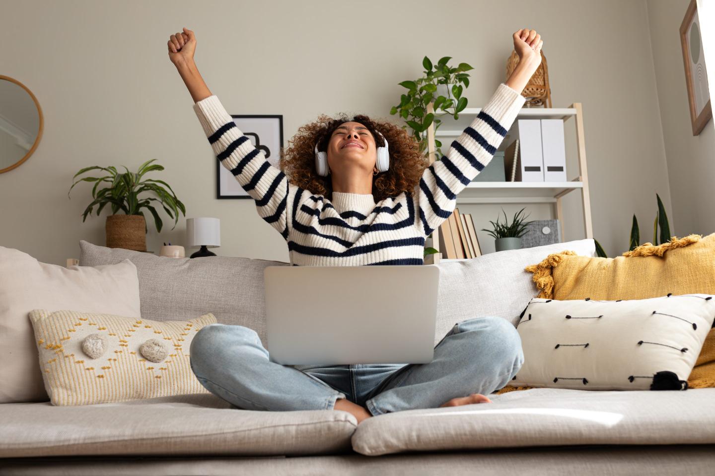 Happy woman working on sofa