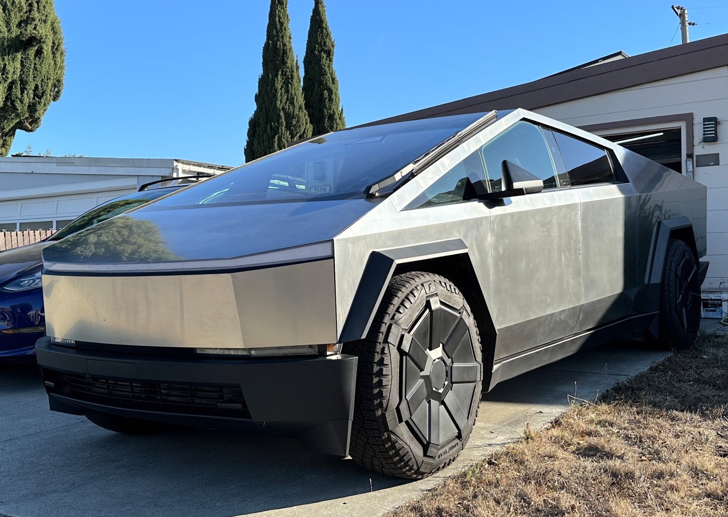 A vehicle from Tesla's electric pickup Cybertruck series parked in front of a garage in Silicon Valley. 