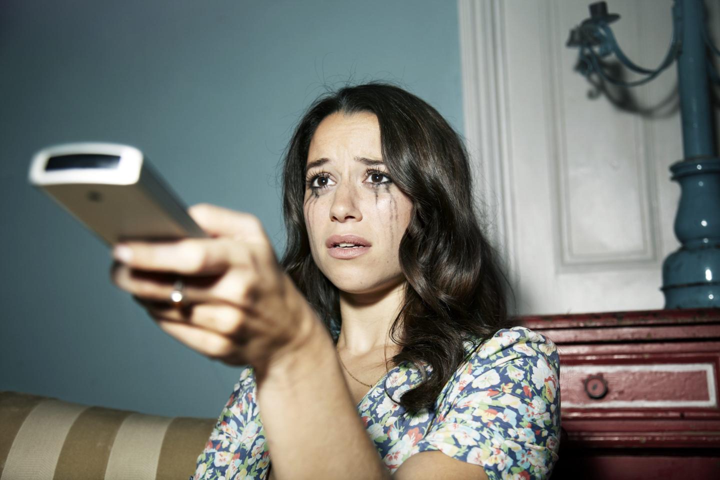 Woman crying while watching TV