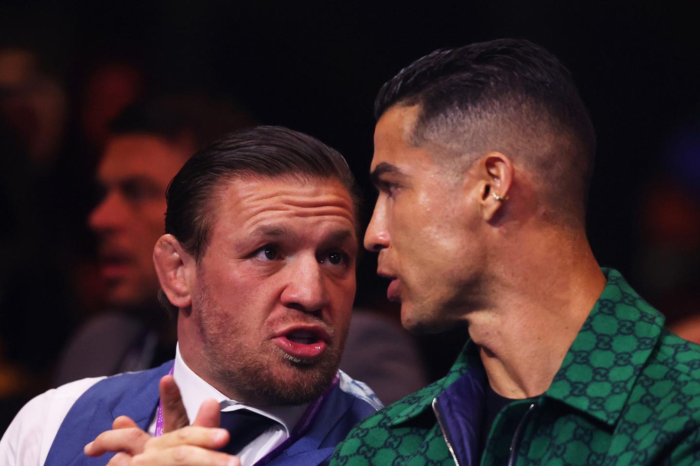 Conor McGregor, Irish Martial Artist and Boxer, and Cristiano Ronaldo, Portuguese football player of Al Nassr, interact during the Day of Reckoning: Fight Night at Kingdom Arena on December 23, 2023 in Riyadh, Saudi Arabia.