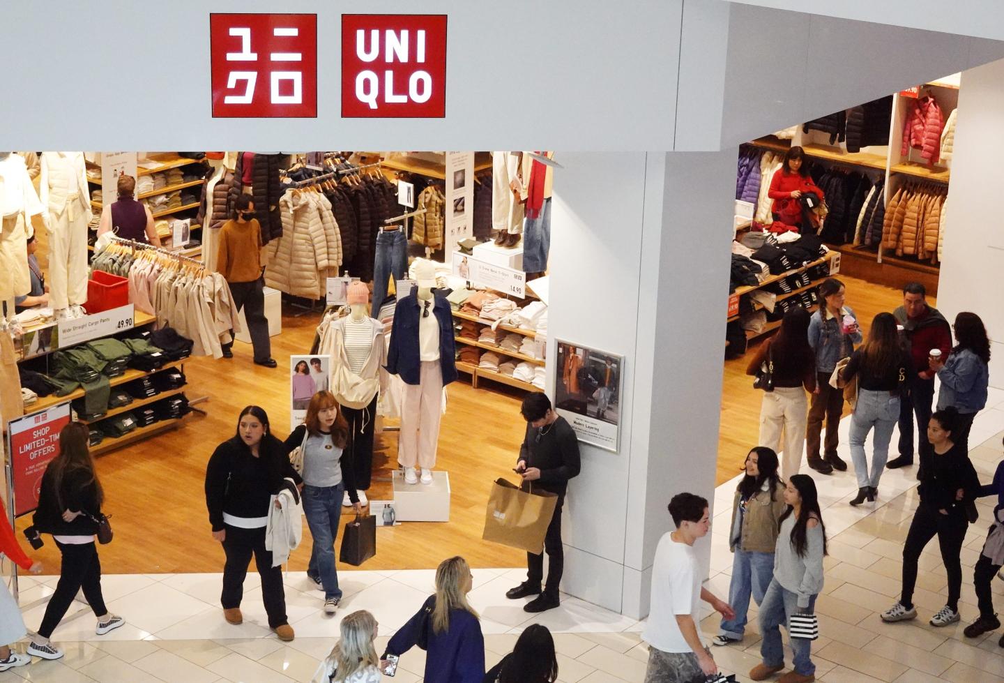 Shoppers walk at a Uniqlo store in the Glendale Galleria shopping mall.