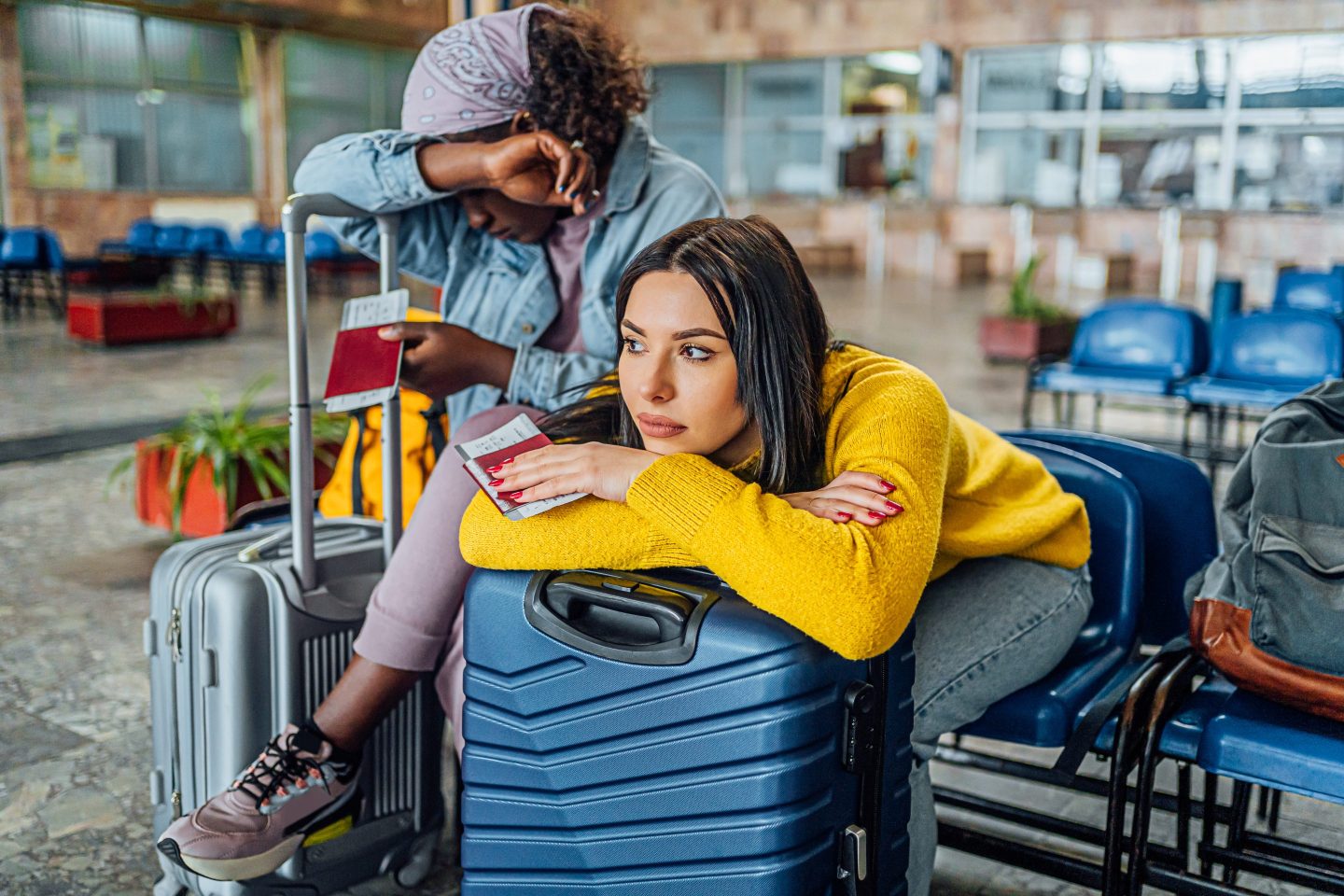 Two women in airport waiting room.