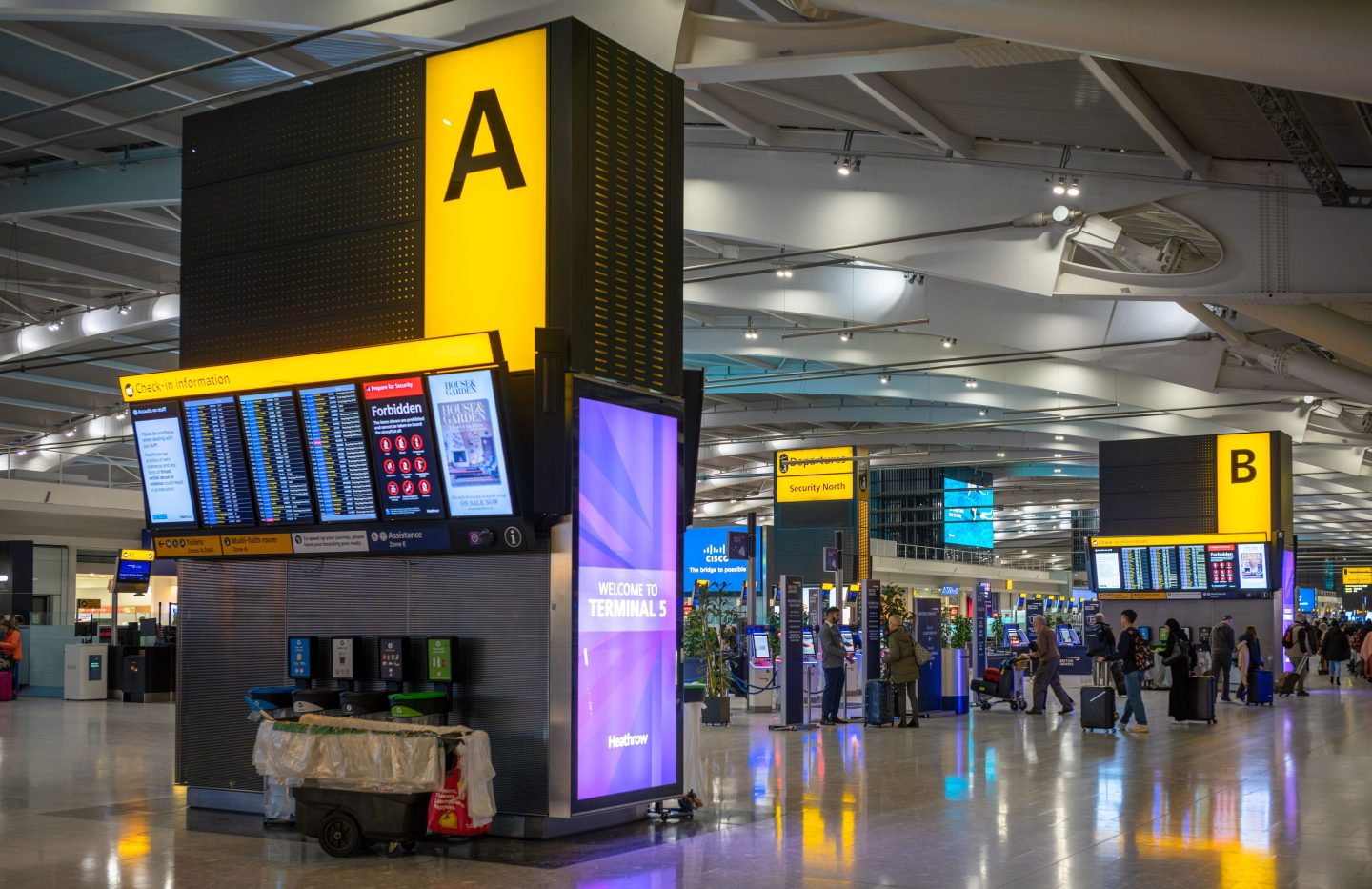 an airport terminal with screens showing flight status