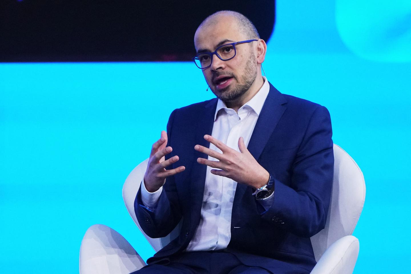 DeepMind co-founder Demis Hassabis in a chair.