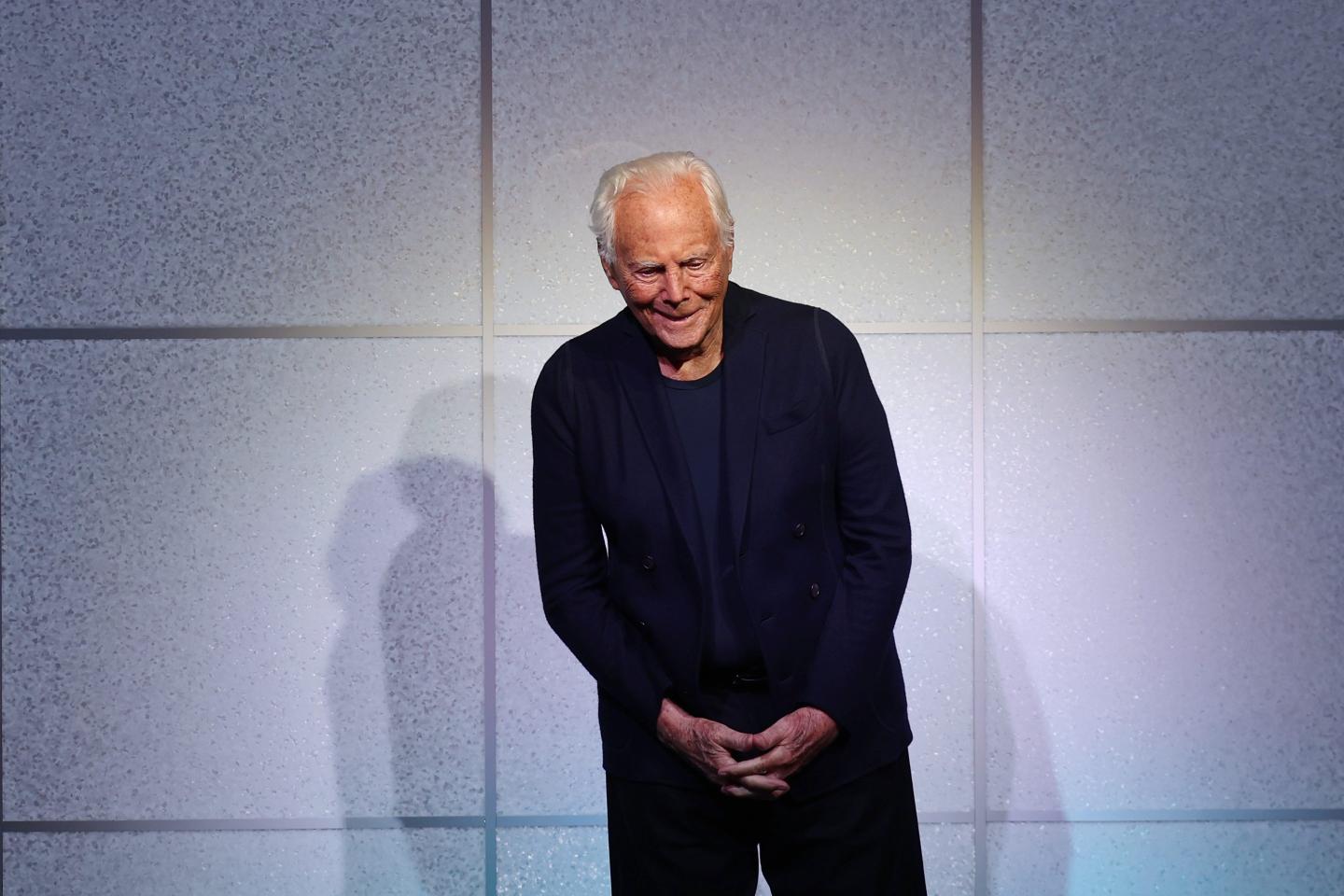 Giorgio Armani standing on a stage
