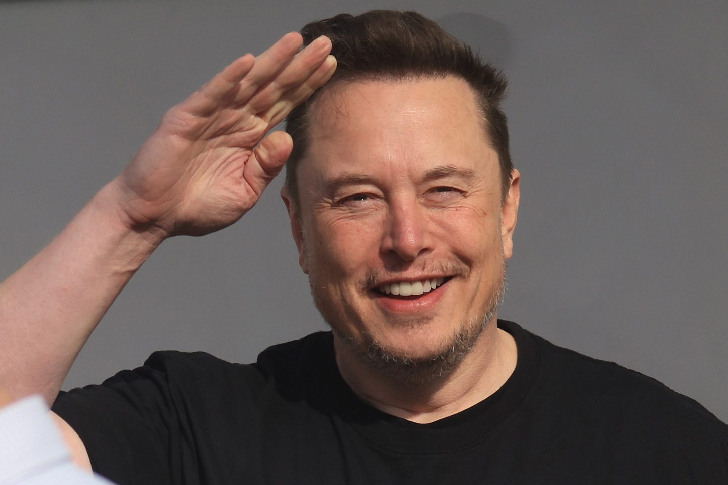 Elon Musk waves his hand