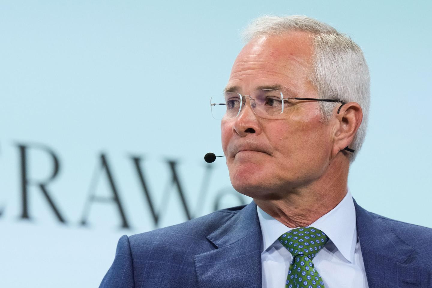person sitting with a microphone and head turned to the right