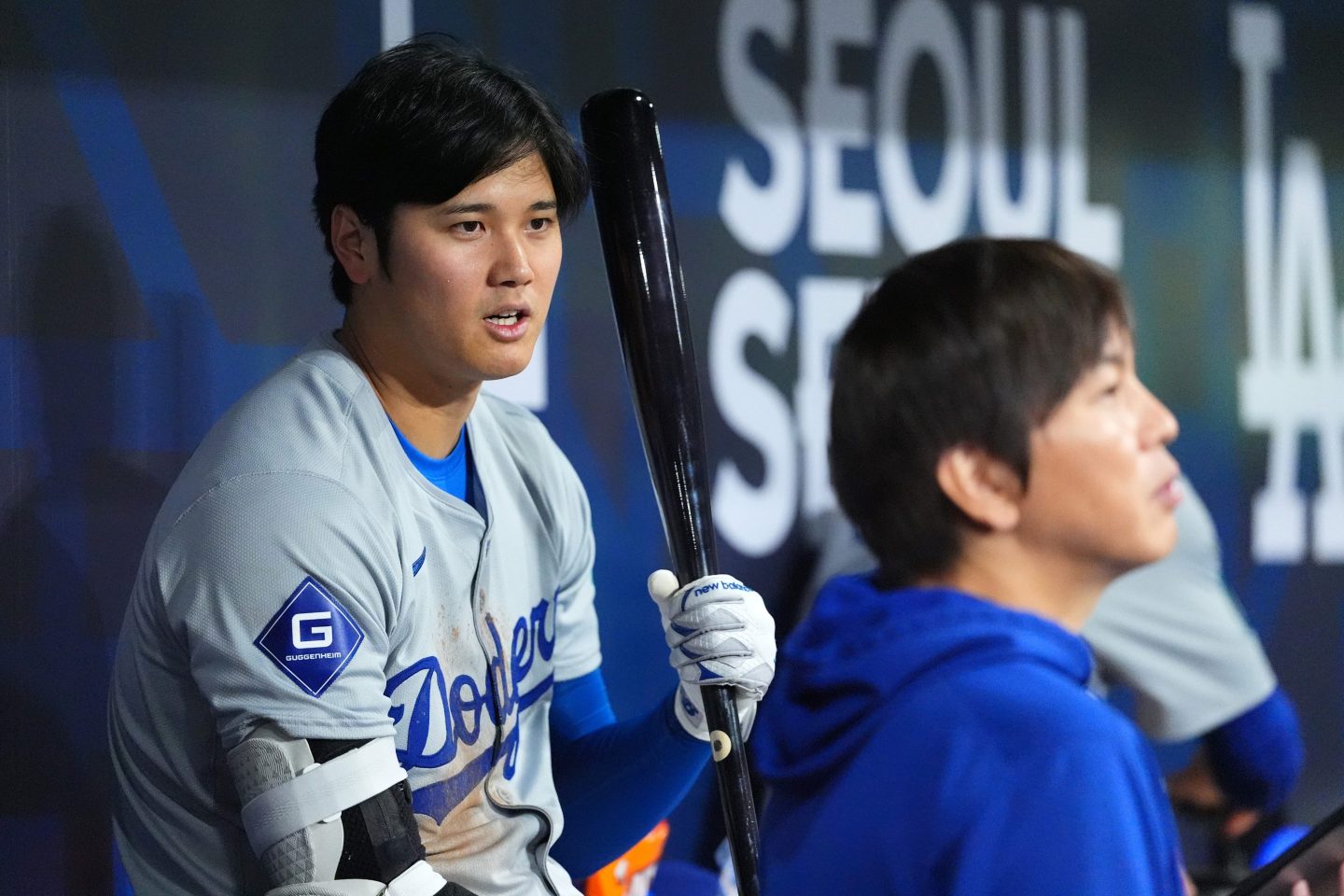 Shohei Ohtani of the Los Angeles Dodgers talks to his interpreter Ippei Mizuhara in the dugout during the 2024 Seoul Series game between the Los Angeles Dodgers and San Diego Padres on Mar. 20.
