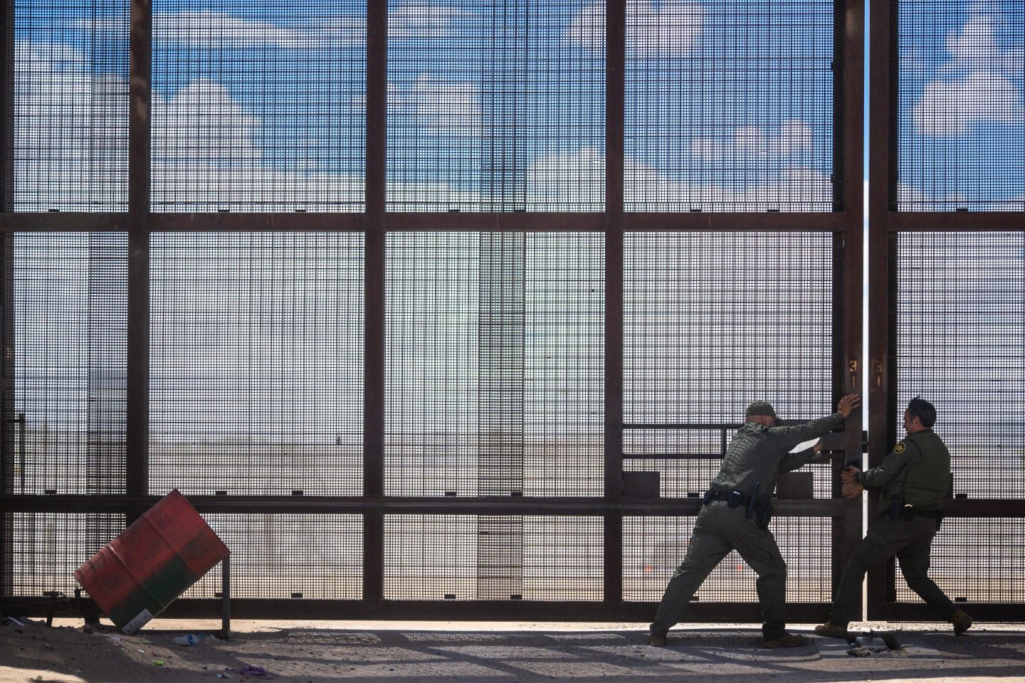 Border patrol agents close a section of border fencing in El Paso, Texas on Mar. 25.
