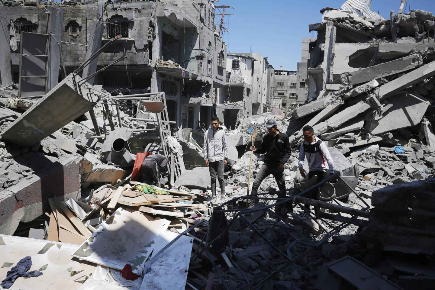 Palestinians living in al-Maghazi Refugee Camp collect the usable items among the rubble of the destroyed buildings following an Israeli attack in Deir al-Balah, Gaza on April 4, 2024.