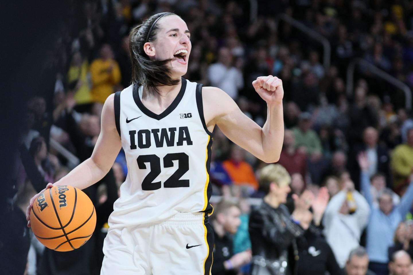 Iowa Hawkeyes basketball player Caitlin Clark celebrating.