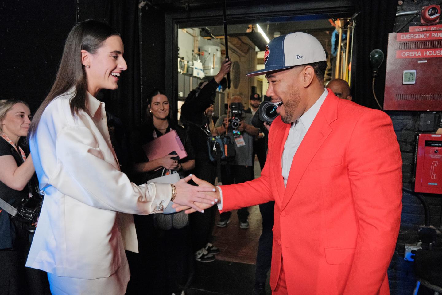 Caitlin Clark greets Jake from State Farm after being drafted first overall by the Indiana Fever the 2024 WNBA Draft on April 15, 2024 at the Brooklyn Academy of Music in Brooklyn, New York. 