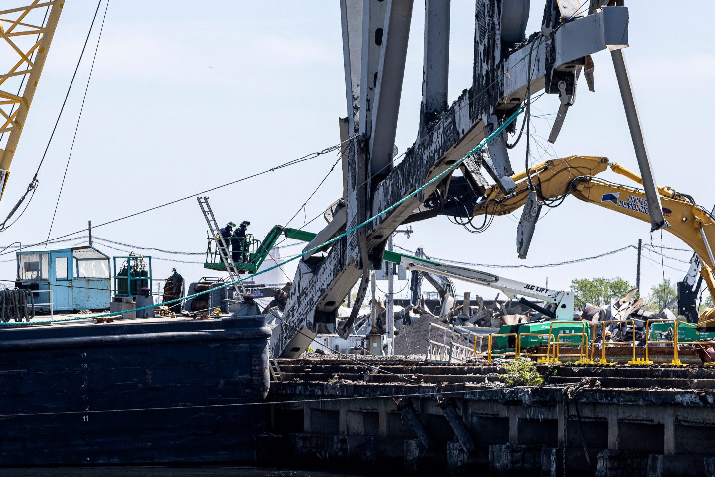 Salvage workers cut part of a truss from the collapsed Francis Scott Key Bridge after it was struck by the Dali container vessel in Baltimore, Maryland, US, on Tuesday, April 23, 2024.