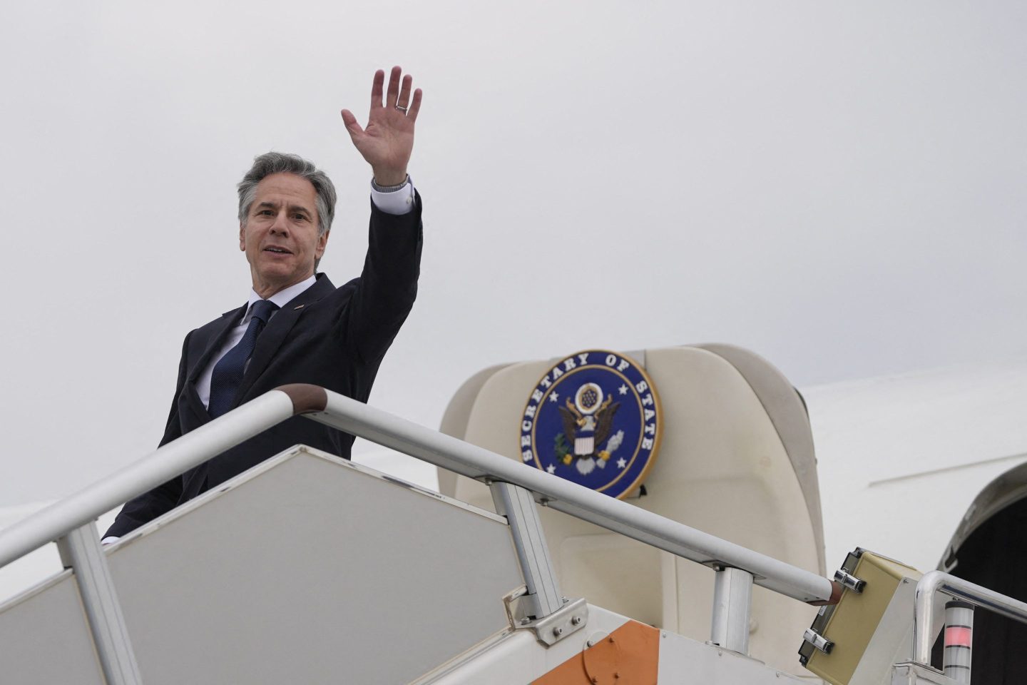 US Secretary of State Antony Blinken waves as he prepares to depart Shanghai