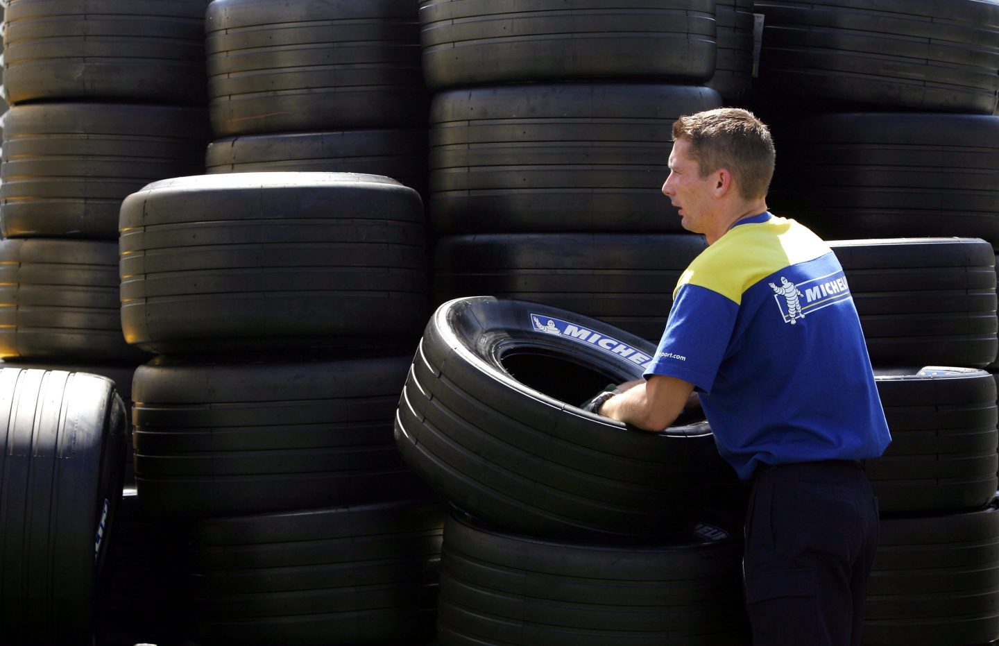 A Michelin tire technician unloads tires in preparation for the Australian Formula One Grand Prix at the Melbourne Grand Prix Circuit