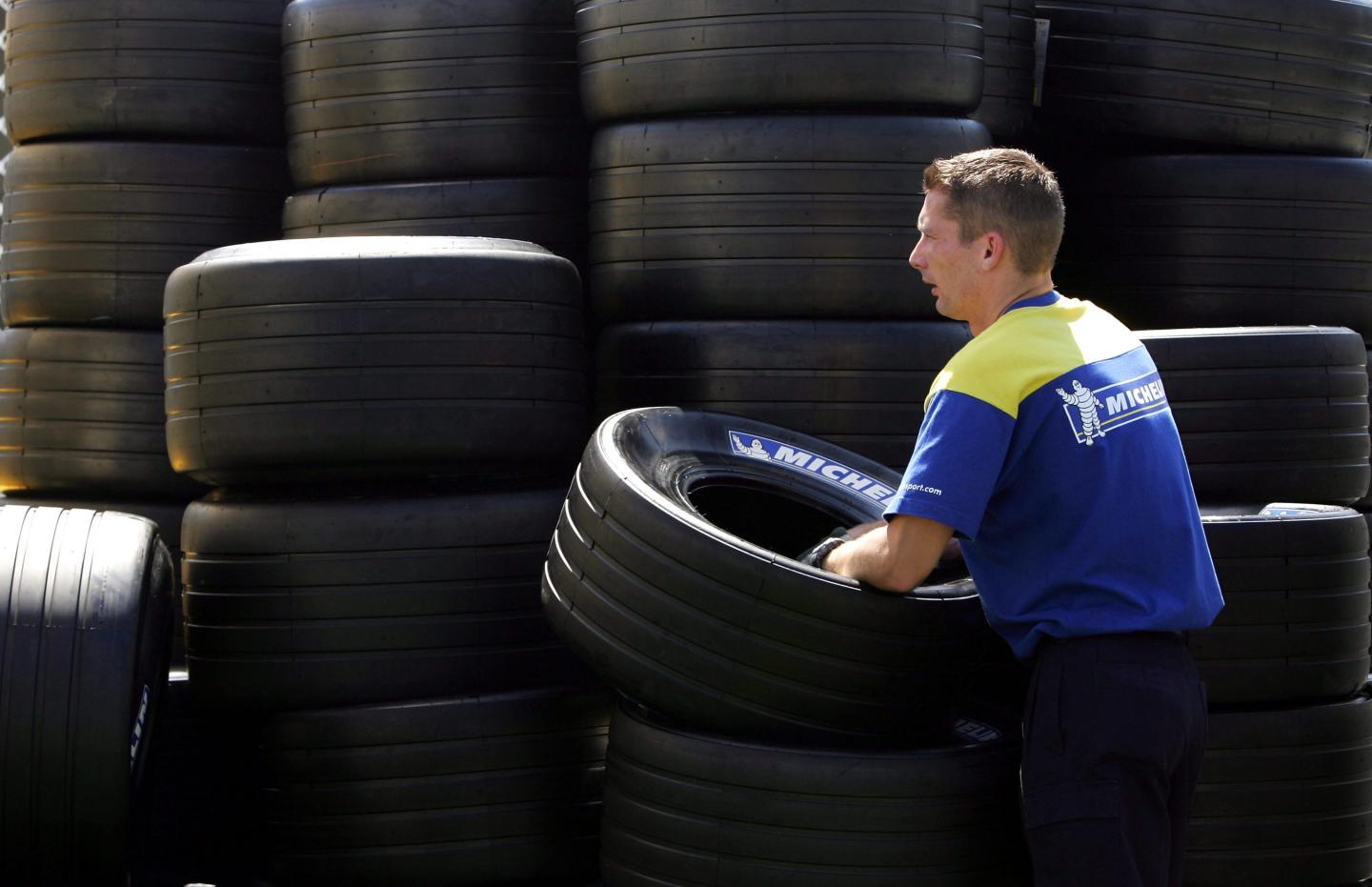 A Michelin tire technician unloads tires in preparation for the Australian Formula One Grand Prix at the Melbourne Grand Prix Circuit