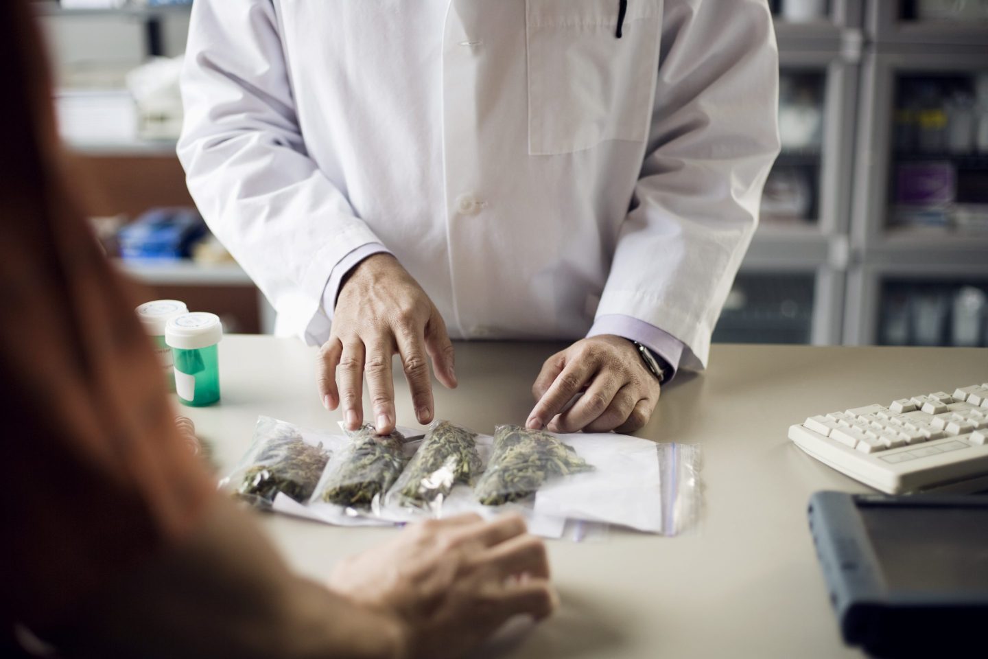 A pharmacist assists a customer with medical marijuana.