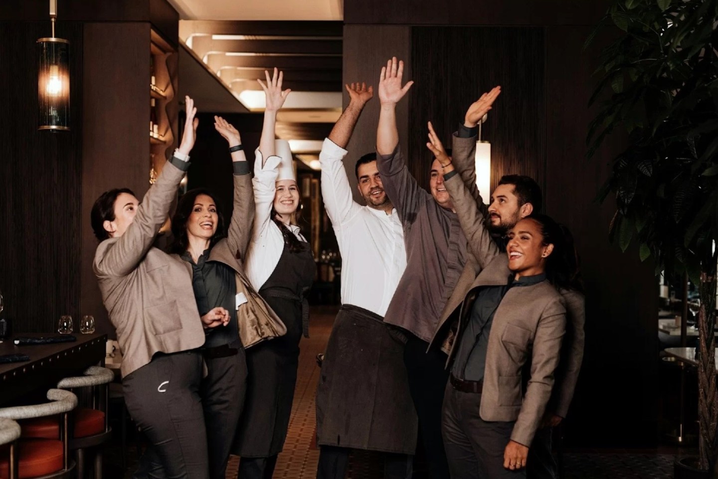 Hilton employees group high-fiving