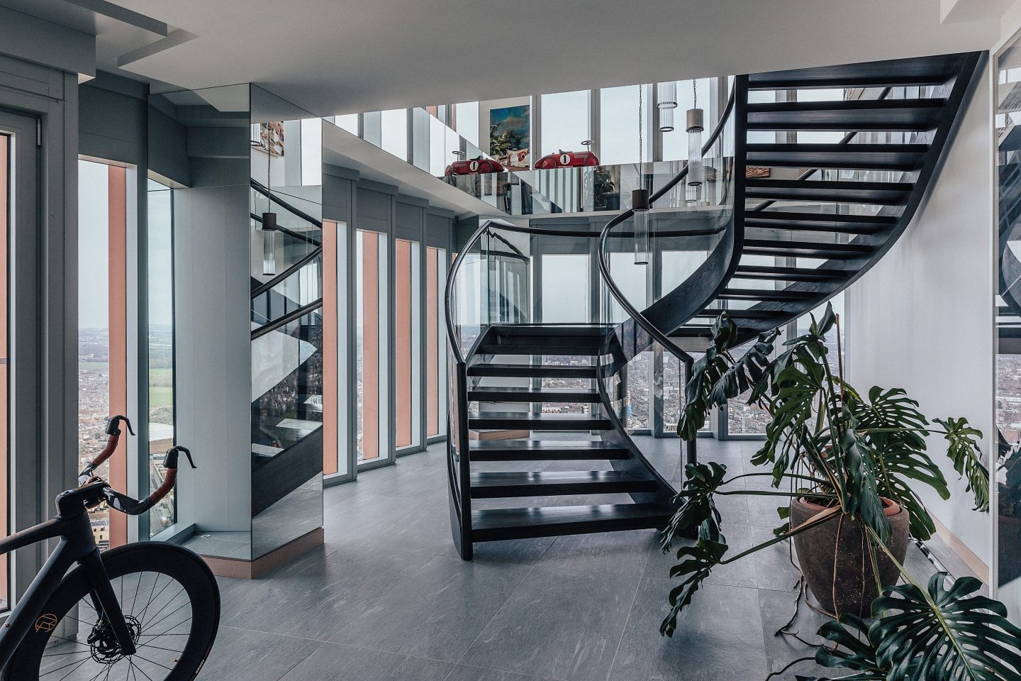 The entrance features a winding iron staircase that leads up to the open-plan primary living space. US-based architect Alex Gorlin undertook the interior design.