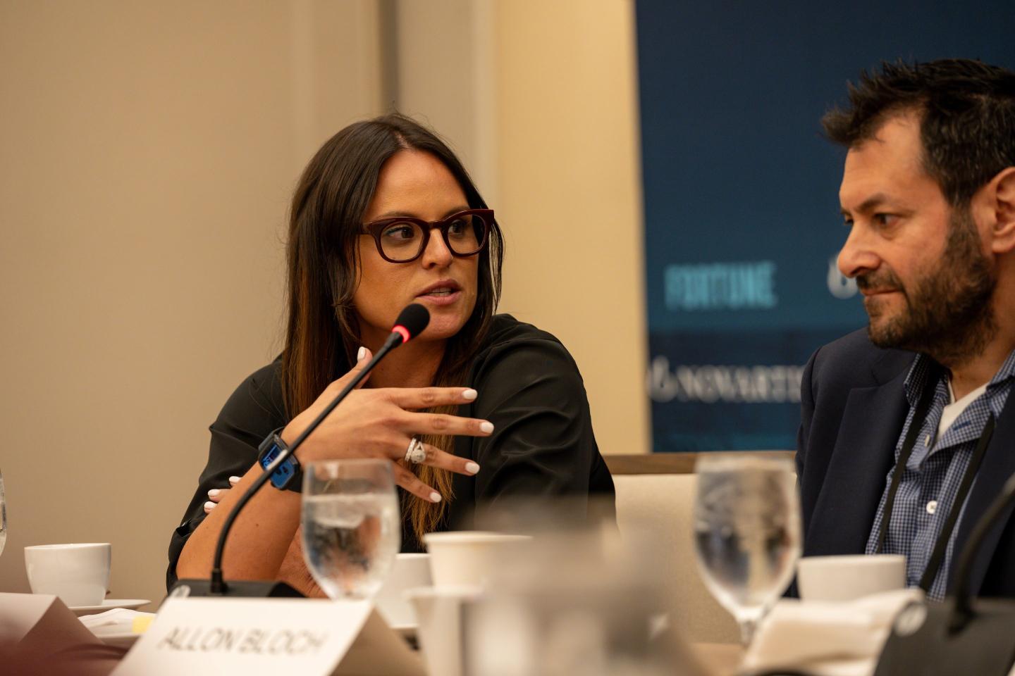 Liana Douillet Guzmán, Chief Executive Officer, FOLX Health, speaking at a microphone