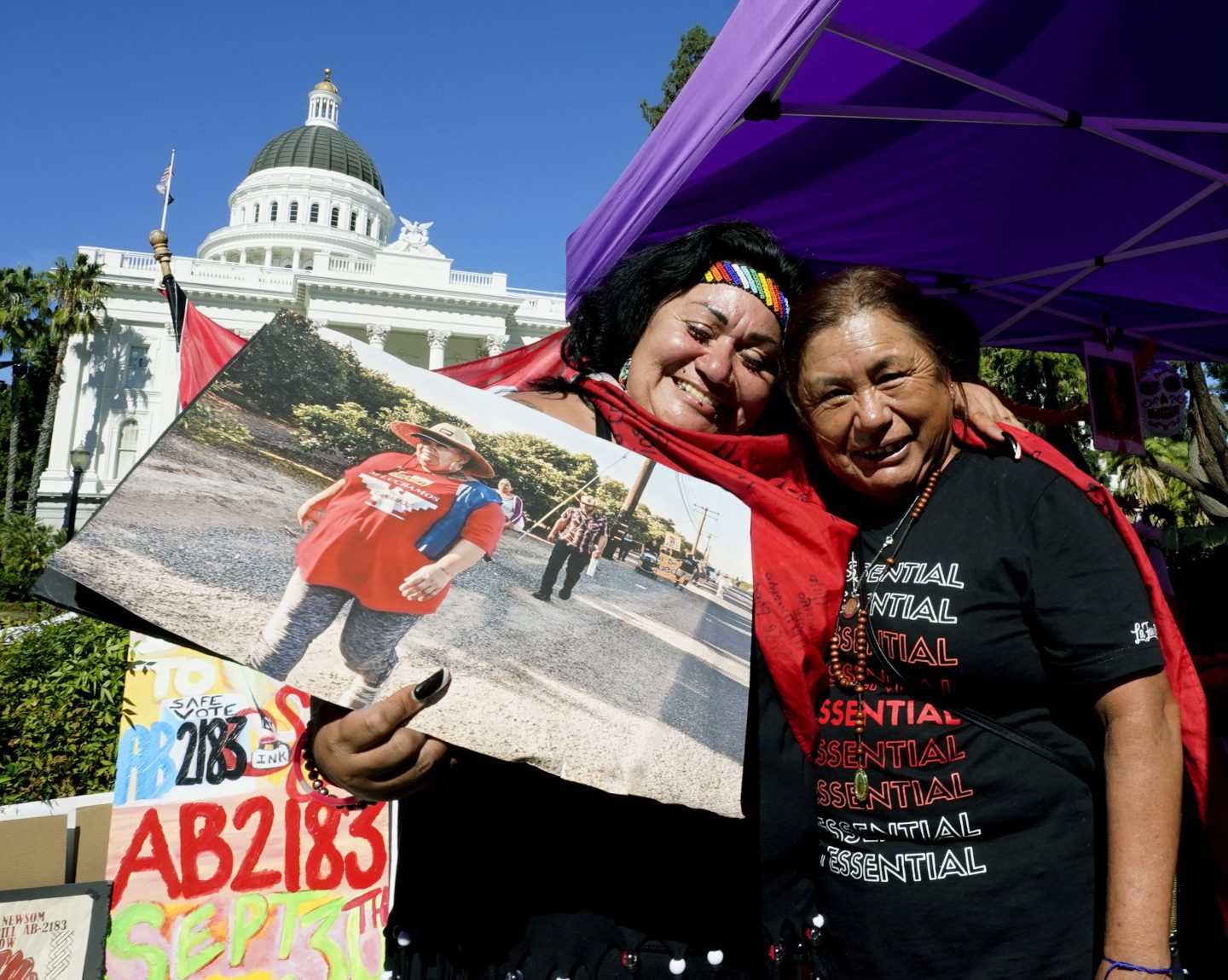 Farmworkers Cynthia Burgos, left and Teresa Maldonado, right, hug after Gov. Gavin Newsom signed a bill aimed at making it easier for farmworkers to unionize in Sacramento, Calif., Sept. 28, 2022.