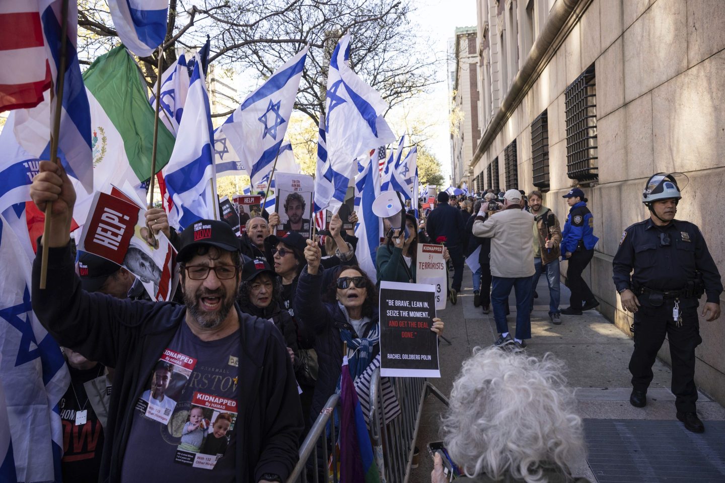 Pro-Israel demonstrators hold signs and march