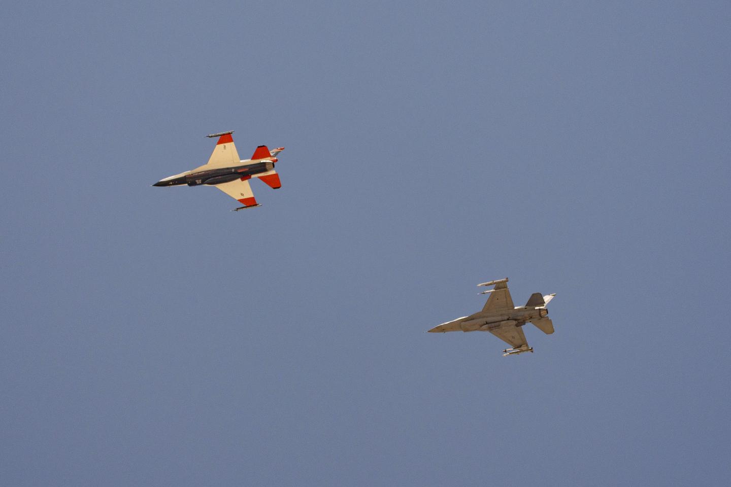 two F-16s fly next to each other