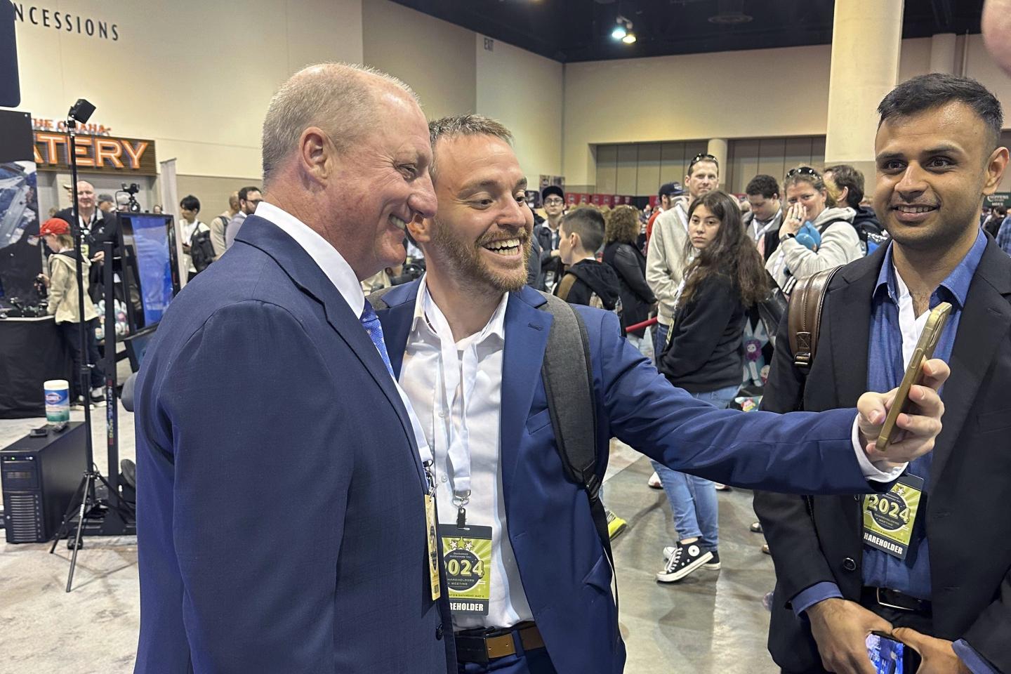 Greg Abel takes selfie with shareholders