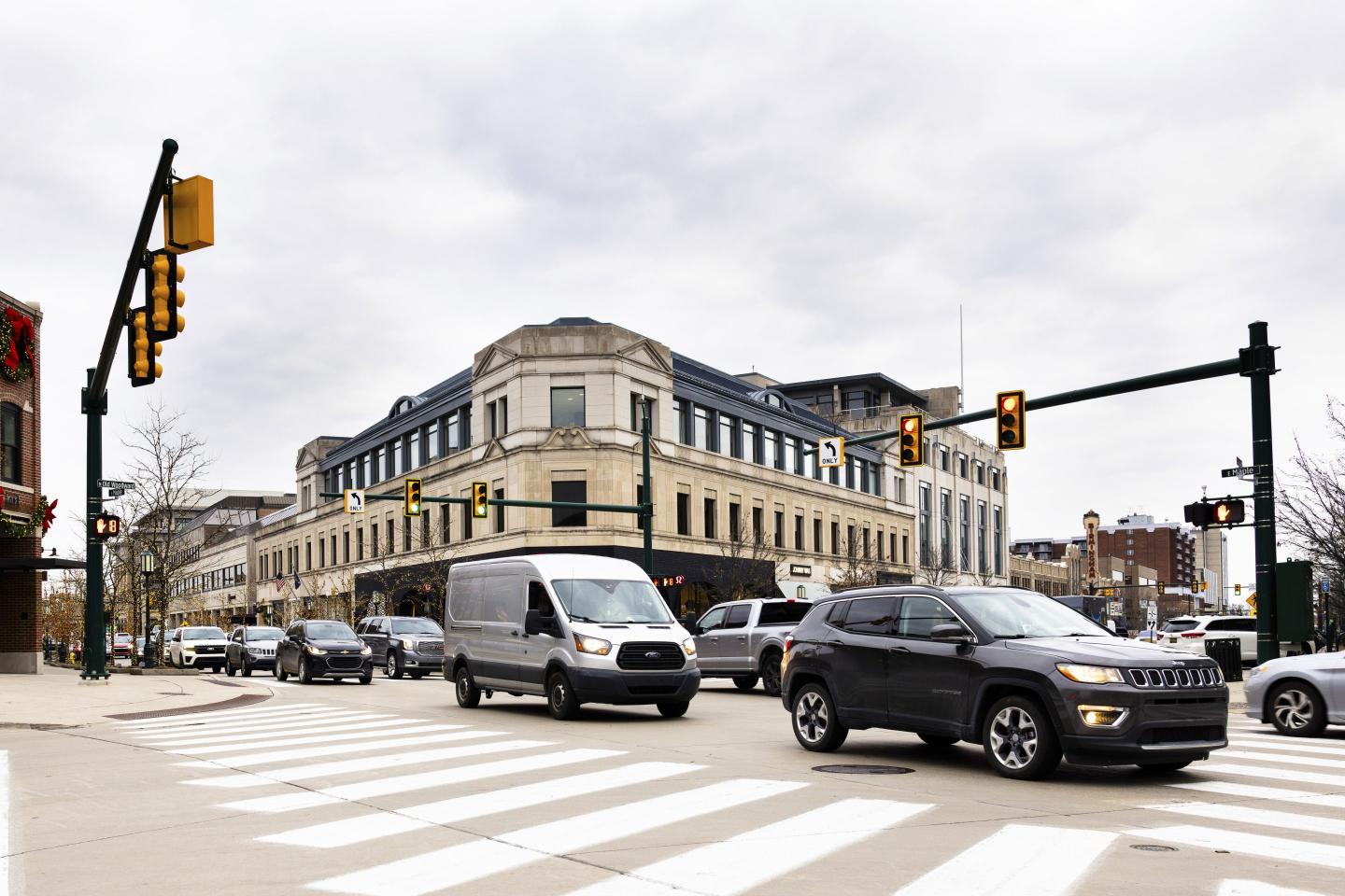cars drive through intersection