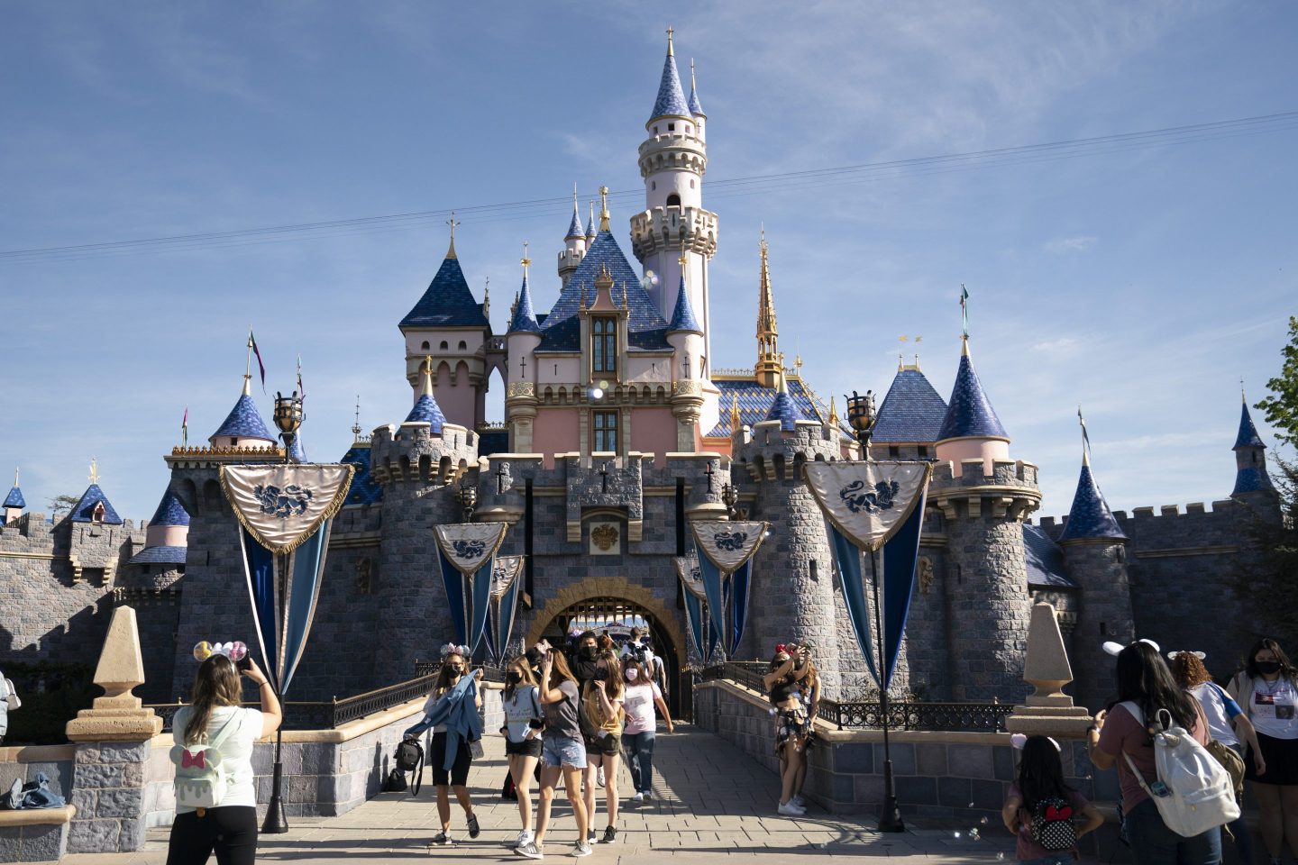 Visitors pass through Disneyland in Anaheim, Calif., on April 30, 2021.