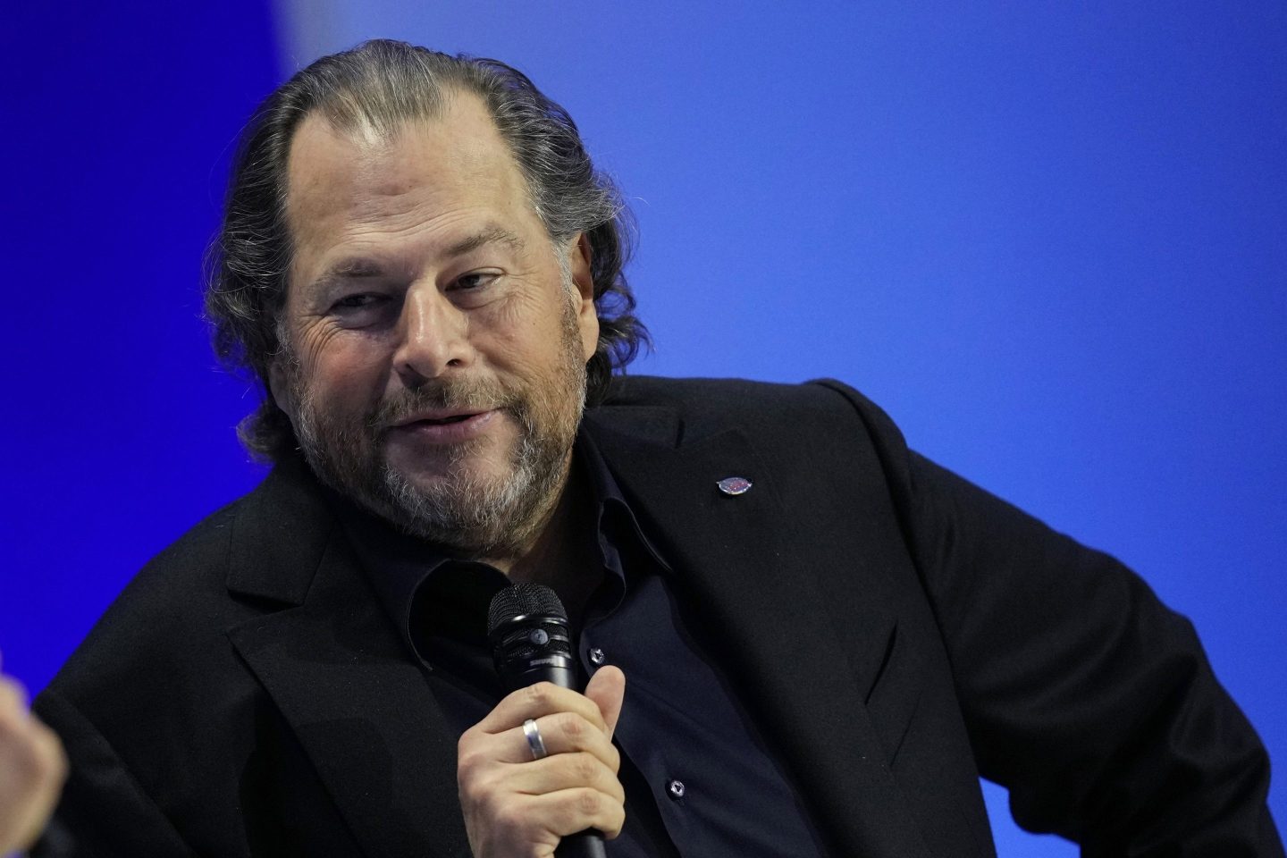 Marc Benioff holds microphone