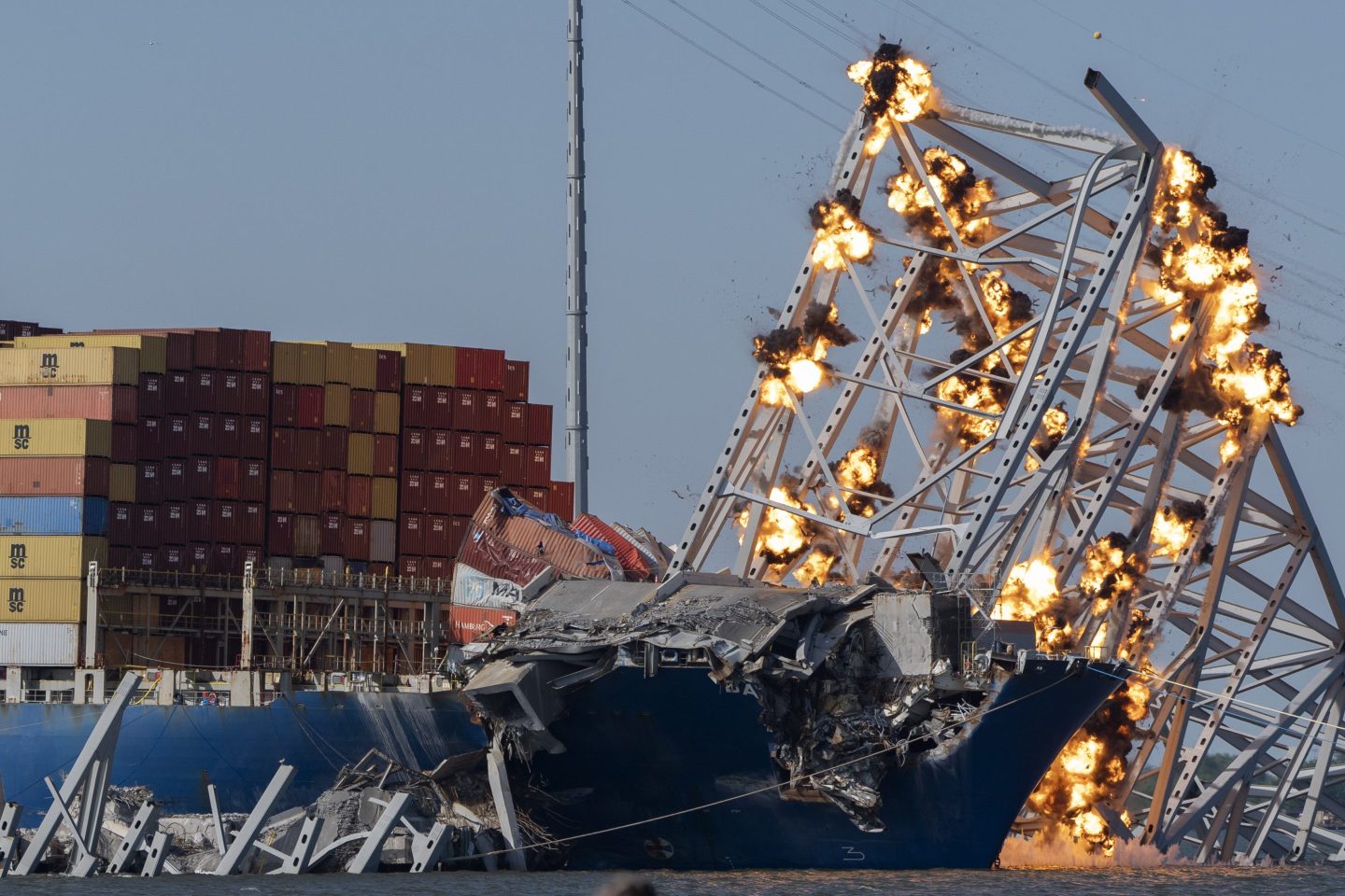 controlled explosions light up collapsed bridge