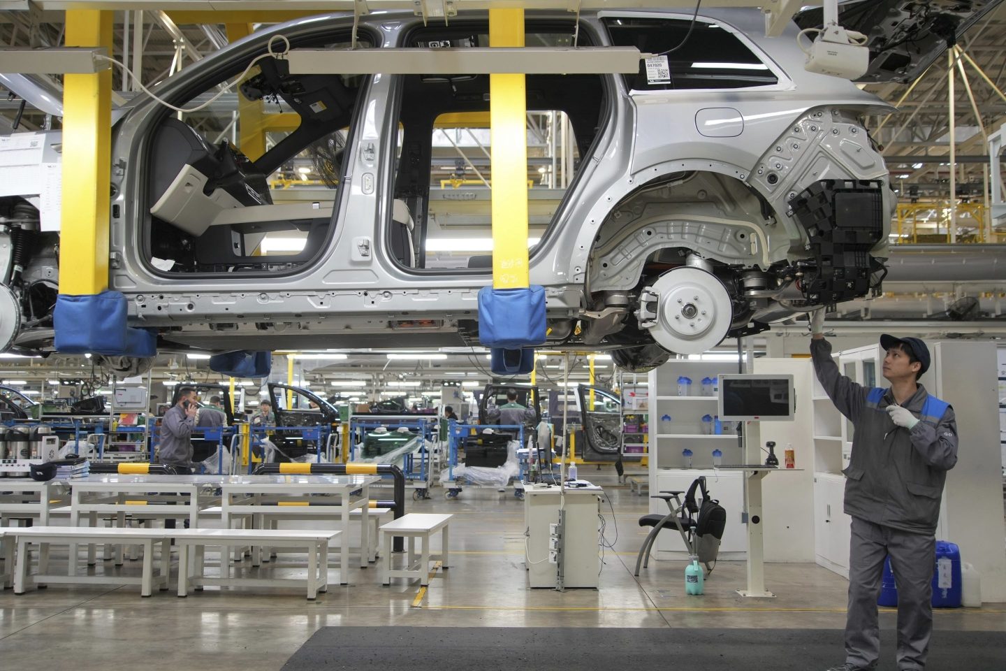 A worker assembles an SUV at a car plant of Li Auto, a major Chinese EV maker, in Changzhou in eastern China's Jiangsu province on March 27, 2024.
