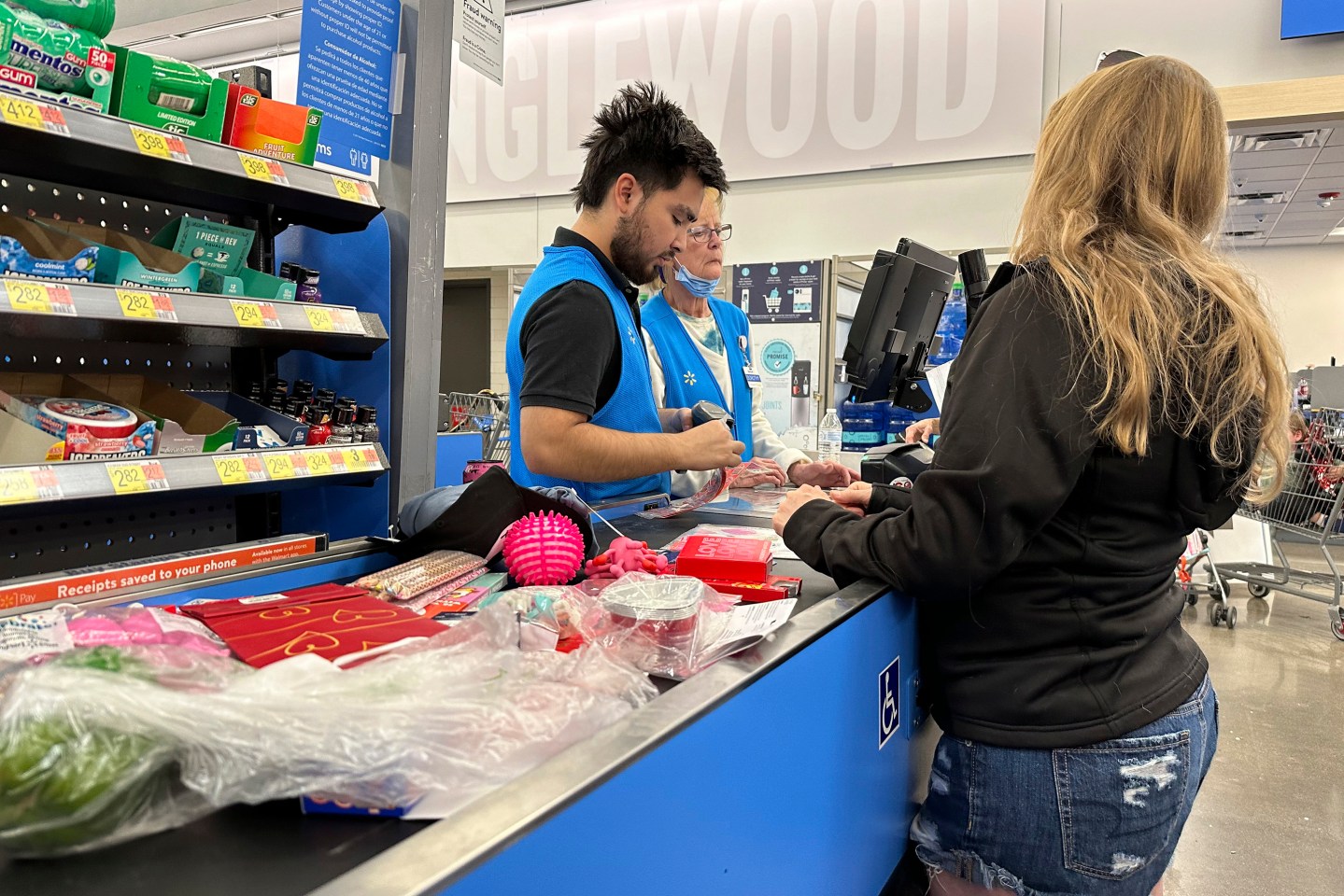 A customer checks out of a Walmart store in Englewood, Colo.