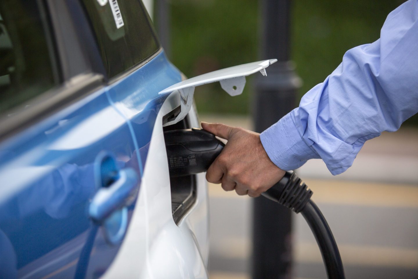 Man charges electric vehicle.