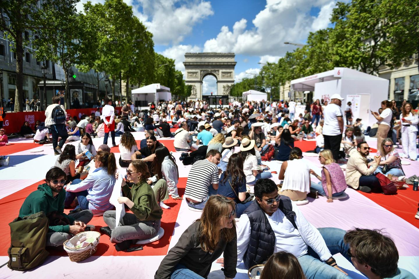 Close up shot of people enjoying a picnic on the Champs-Elysées