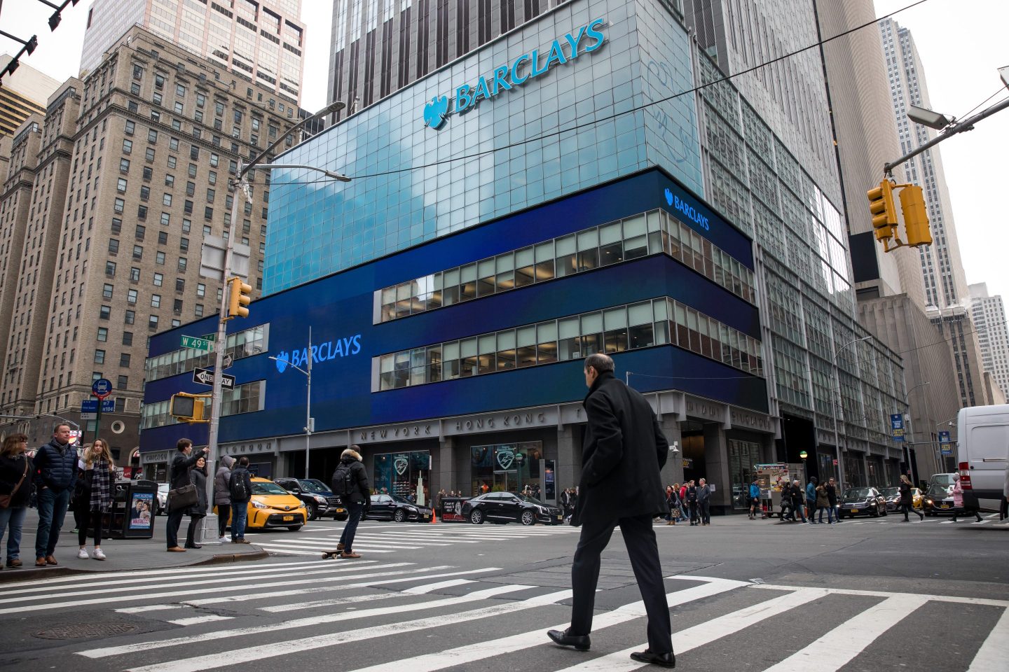 Pedestrians pass in front of Barclays PLC headquarters in New York, on Feb. 22, 2019.