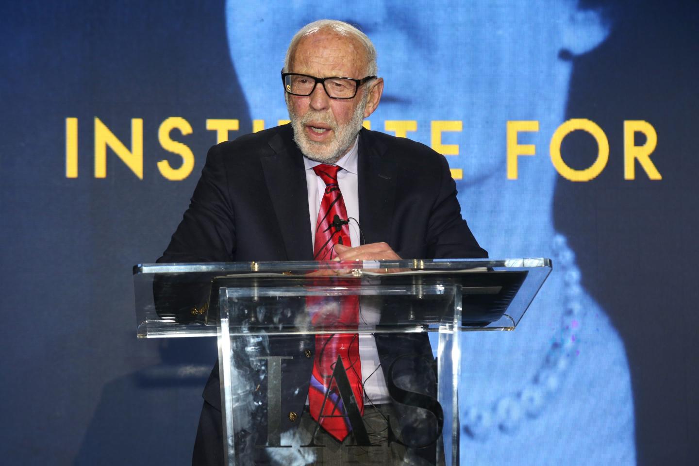 Jim Simons speaks at podium