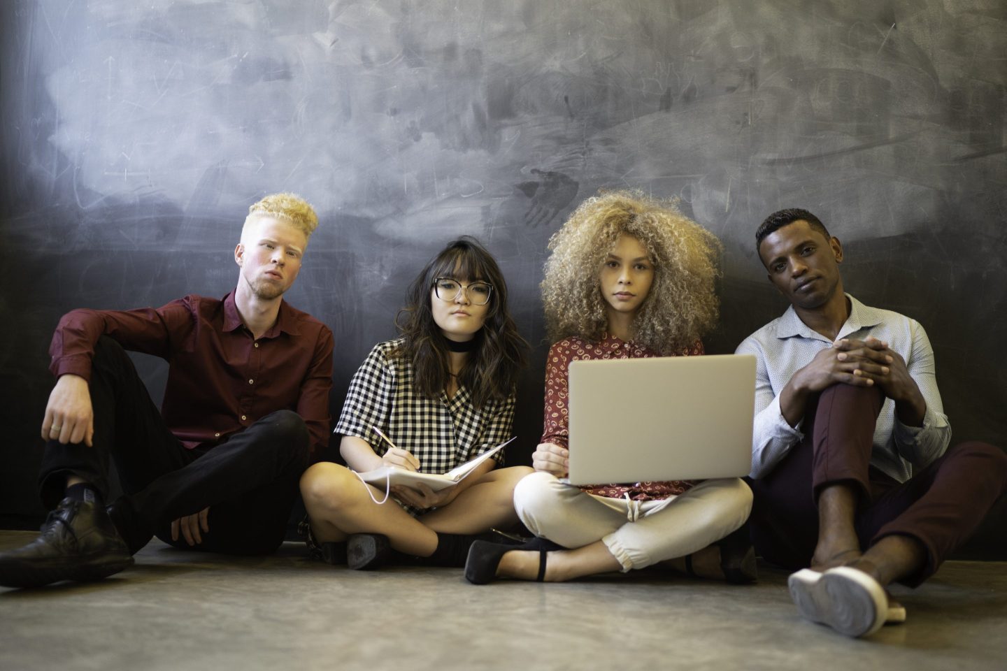 Business team portrait sitting on the floor.