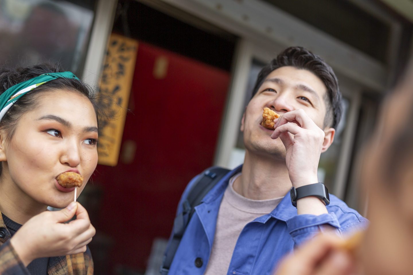 Friends Sharing Take Away Chicken on the Street in Japan