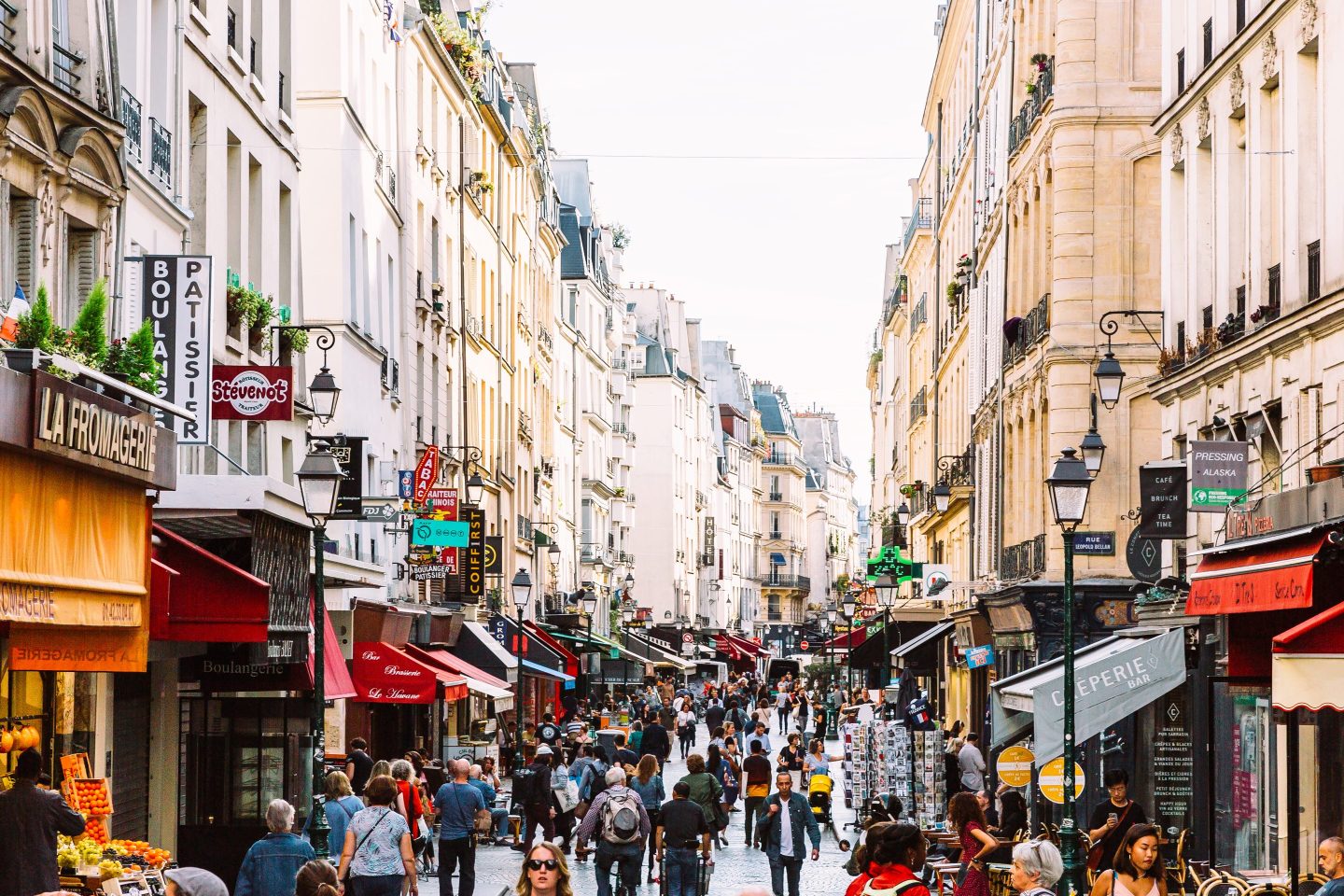 Crowds of people at Rue Montorgueil pedestrian street in Paris, France