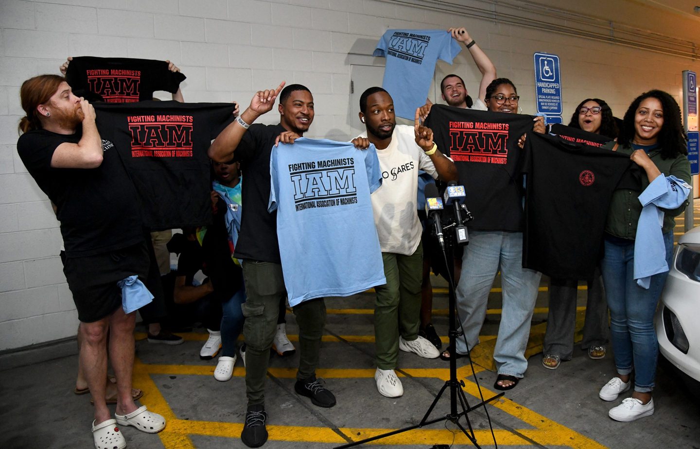 workers hold union shirts