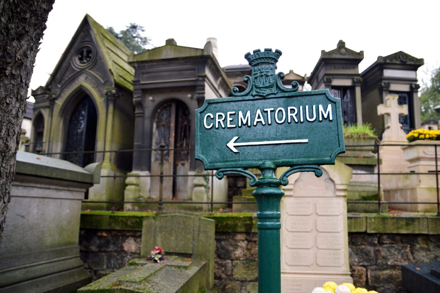 a sign in a cemetery points to a crematorium