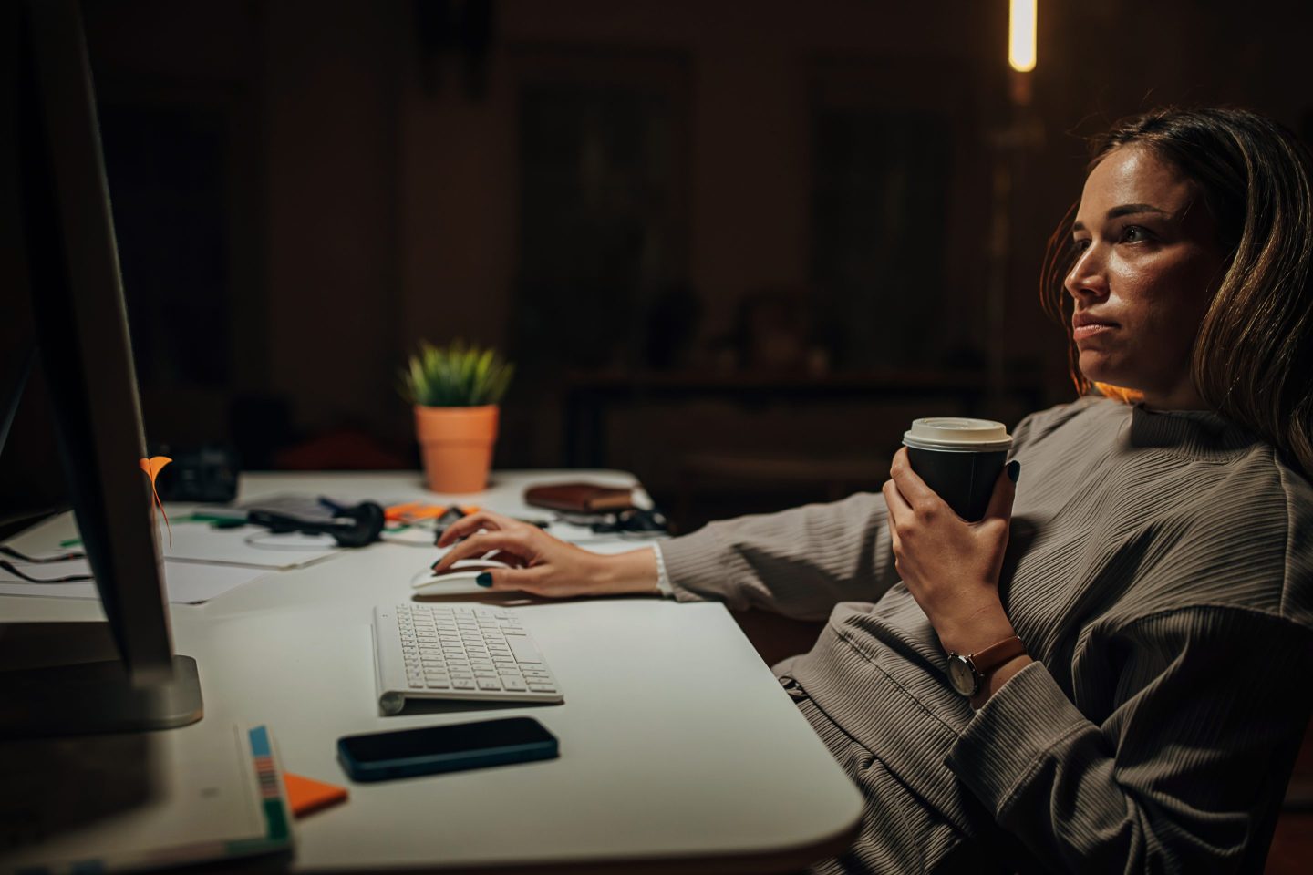 Woman looks at her laptop.